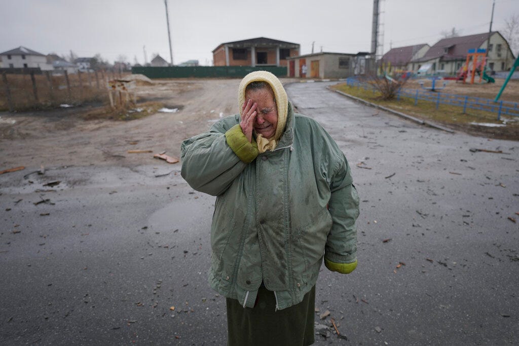 A woman cries outside houses damaged by a Russian airstrike, according to locals, in Gorenka, outside the capital Kyiv, Ukraine (AP Photo/Vadim Ghirda)